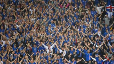 Iceland supporters cheer after the  Euro 2016 quarter-final football match between France and Iceland at the Stade de France in Saint-Denis, near Paris, on July 3, 2016.  / AFP PHOTO / Francisco LEONG